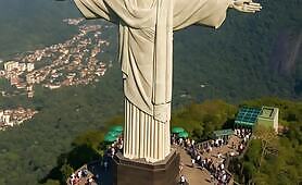 Crowds_talk_around_and_watches_huge_jesus_stature_glowing_a_bit1748723047597